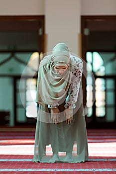 Young beautiful Muslim Woman Praying In Mosque