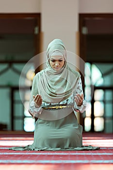 Young beautiful Muslim Woman Praying In Mosque