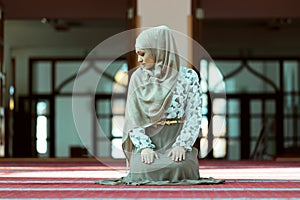 Young beautiful Muslim Woman Praying In Mosque