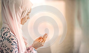 Young beautiful muslim women open palm, peaceful praying in mosque