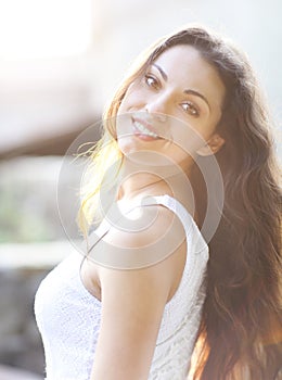 Young beautiful natural brunette woman at summer sunset portrait