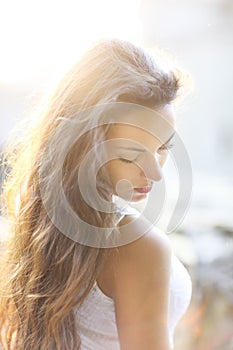Young beautiful natural brunette woman at summer sunset, portrait. Happiness fun and harmony concept
