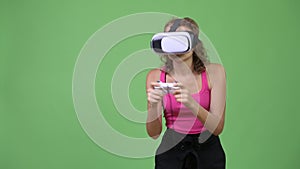 Young beautiful nerd woman playing games and using virtual reality headset