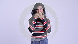 Young beautiful Persian woman showing speak no evil concept