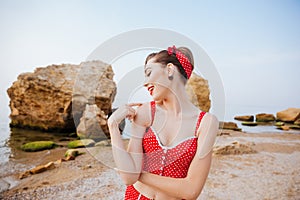 Young beautiful pin up girl in red swimsuit posing
