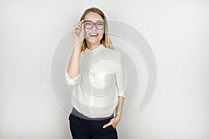 Young beautiful pleased blonde business woman in eyeglasses after successful business meeting isolated white background