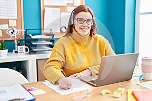 Young beautiful plus size woman call center agent smiling confident working at office