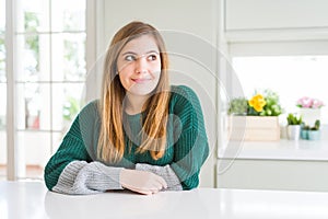 Young beautiful plus size woman wearing casual striped sweater smiling looking to the side and staring away thinking