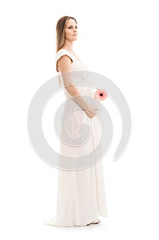 Young and beautiful pregnant woman in antique dress over grey background