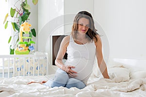 Young beautiful pregnant woman, in pain with labor contraction