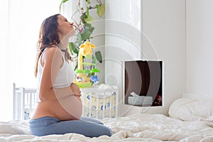 Young beautiful pregnant woman, in pain with labor contraction