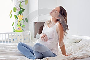 Young beautiful pregnant woman, in pain with labor contraction