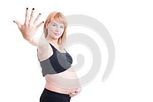 Young beautiful pregnant woman showing number five