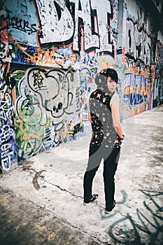 Young beautiful punk emo Coat with Hood background graffiti