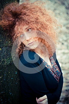 Young beautiful red curly hair woman