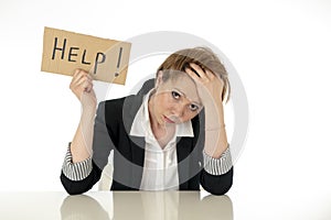 Beautiful young business woman overwhelmed and tired holding a help sign