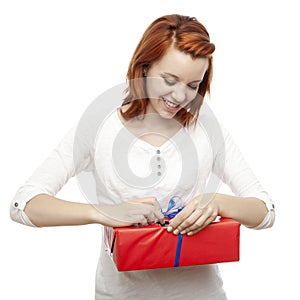 Young beautiful red haired girl open present box