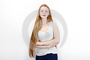 Young beautiful redhead beginner model woman in white t-shirt blue jeans practicing posing showing emotions standing against white