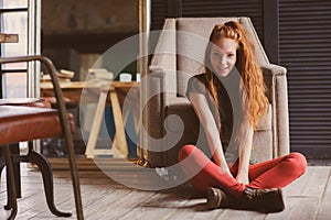 Young beautiful redhead hipster woman with no make up relaxing at home