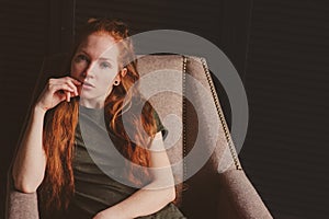 Young beautiful redhead hipster woman with no make up relaxing at home
