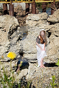 Young beautiful redhead woman in dress barefoot