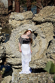 Young beautiful redhead woman in dress barefoot