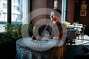 Young beautiful retro lady in cafe