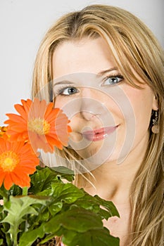 Young beautiful retro woman with flowers in a pot