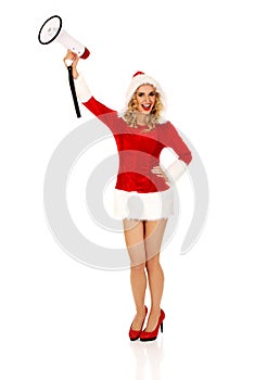 Young beautiful santa woman holding megaphone