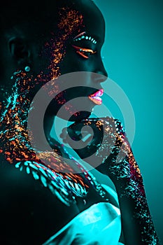 Young sensual woman in fluorescent paint makeup photo