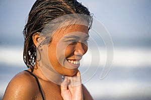 Young beautiful and sexy Asian girl in bikini with wet hair enjoying holidays at tropical beach posing cool smiling happy at the