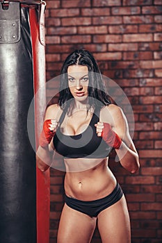 Young beautiful boxer woman with red boxing