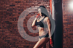 Young beautiful boxer woman with red boxing