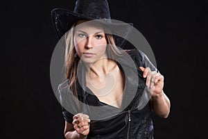 Young beautiful girl leather jacket and black cowboy hat