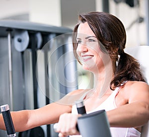 Beautiful woman man couple are doing a workout in the fitnes gym - chest press, bench