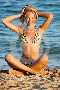 Young beautiful tanned blond woman in bikini