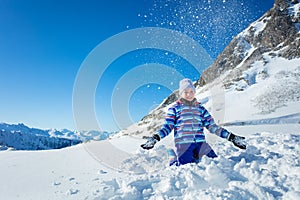 Young beautiful ski girl portrait throw up snow