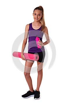 young beautiful slim teen girl holding the yoga mat and water bottle. Full length shot isolated on white background