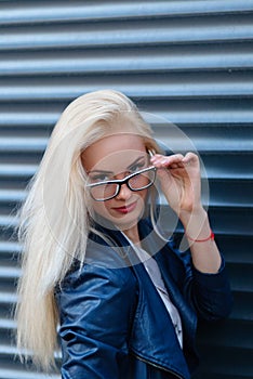 Young beautiful smiling blonde girl with beautiful appearance and long hair. Portrait of a woman with long hair and amazing looks.