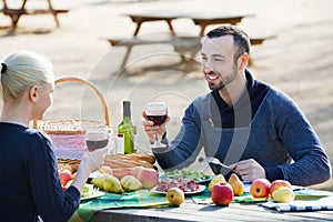 Young beautiful smiling couple drinking wine