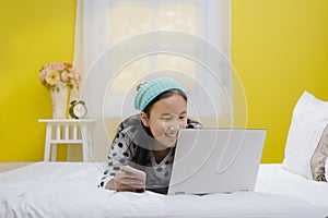 Young beautiful smiling teenage girl using laptop computer