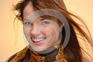 Young beautiful smiling woman in autumn scarf