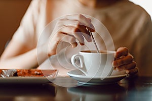 Young beautiful smiling woman enjoying drinking cappuccino coffee cup indoor cafe. Tea or coffee drink