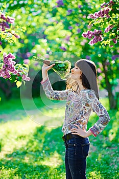 Young beautiful smiling woman smells small bouquet