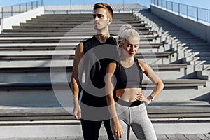 Young beautiful sportive couple, in sportswear, doing sports exercises outdoors, sport, healthy lifestyle