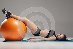 The young, beautiful, sports girl doing exercises on a fitball