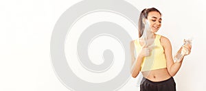 Young sports. Yellow grey clothing. A healthy lifestyle. Banner advertising drinking water for sports. Woman smiles happy