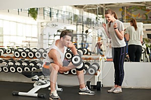 Young beautiful sporty couple at gym.