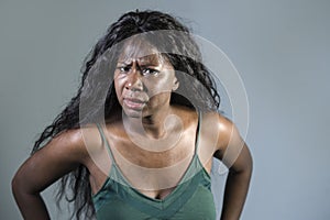 Young beautiful and stressed black African American woman feeling upset and angry gesturing agitated and looking crazy and