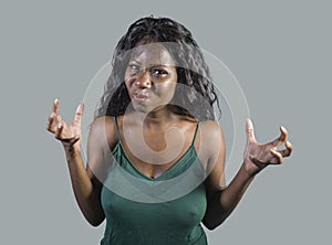 Young beautiful and stressed black African American woman feeling upset and angry gesturing agitated and looking crazy and